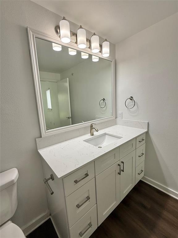 6740 Windhaven Parkway, Unit 5907 The Colony, TX 75056 - Photo 5 of 20 a bathroom with a granite countertop sink a toilet and a mirror
