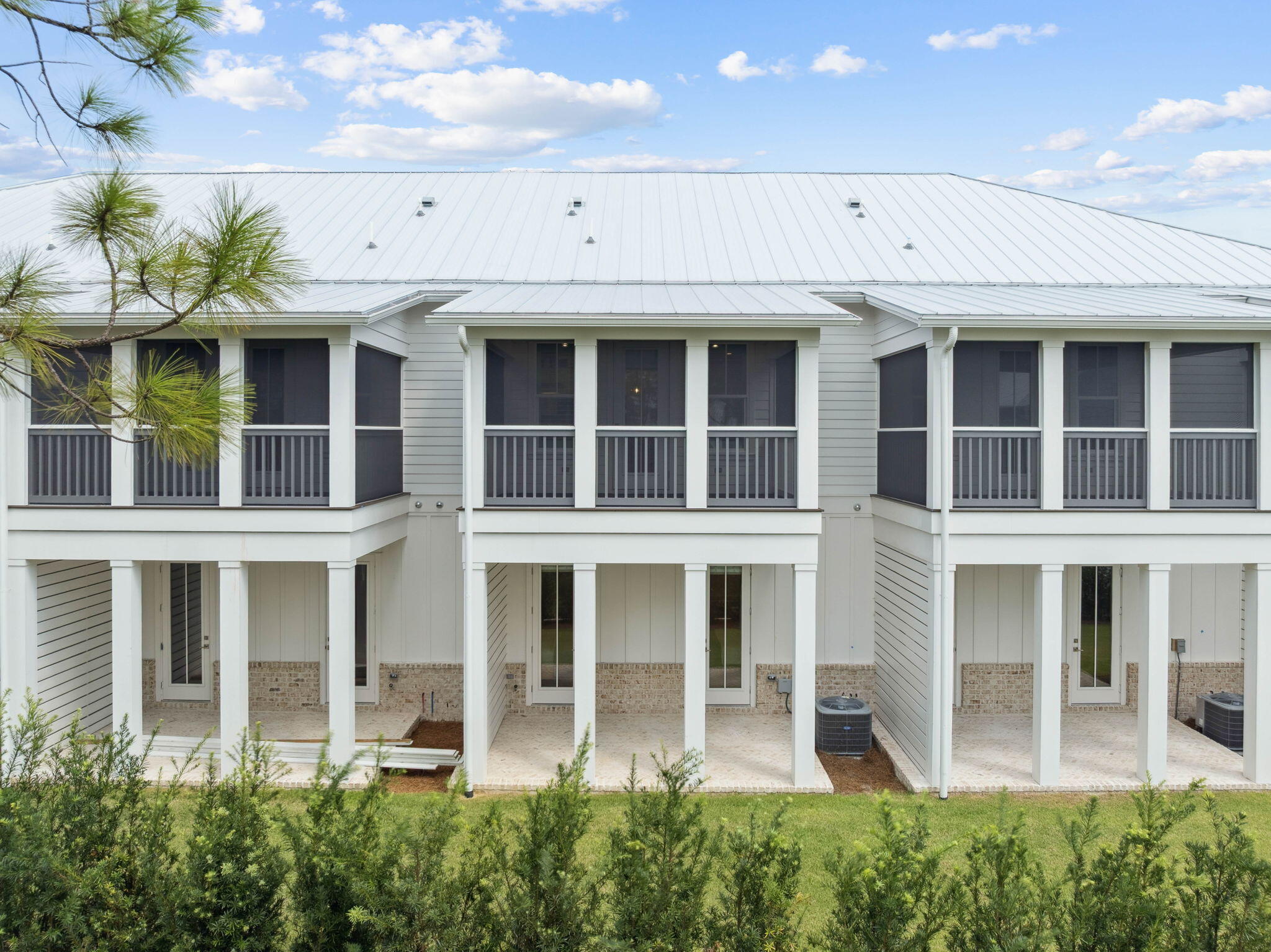 45 Grove Townhomes Place, Unit 104 Santa Rosa Beach, FL 32459 - Photo 2 of 36 a view of a brick building with large windows