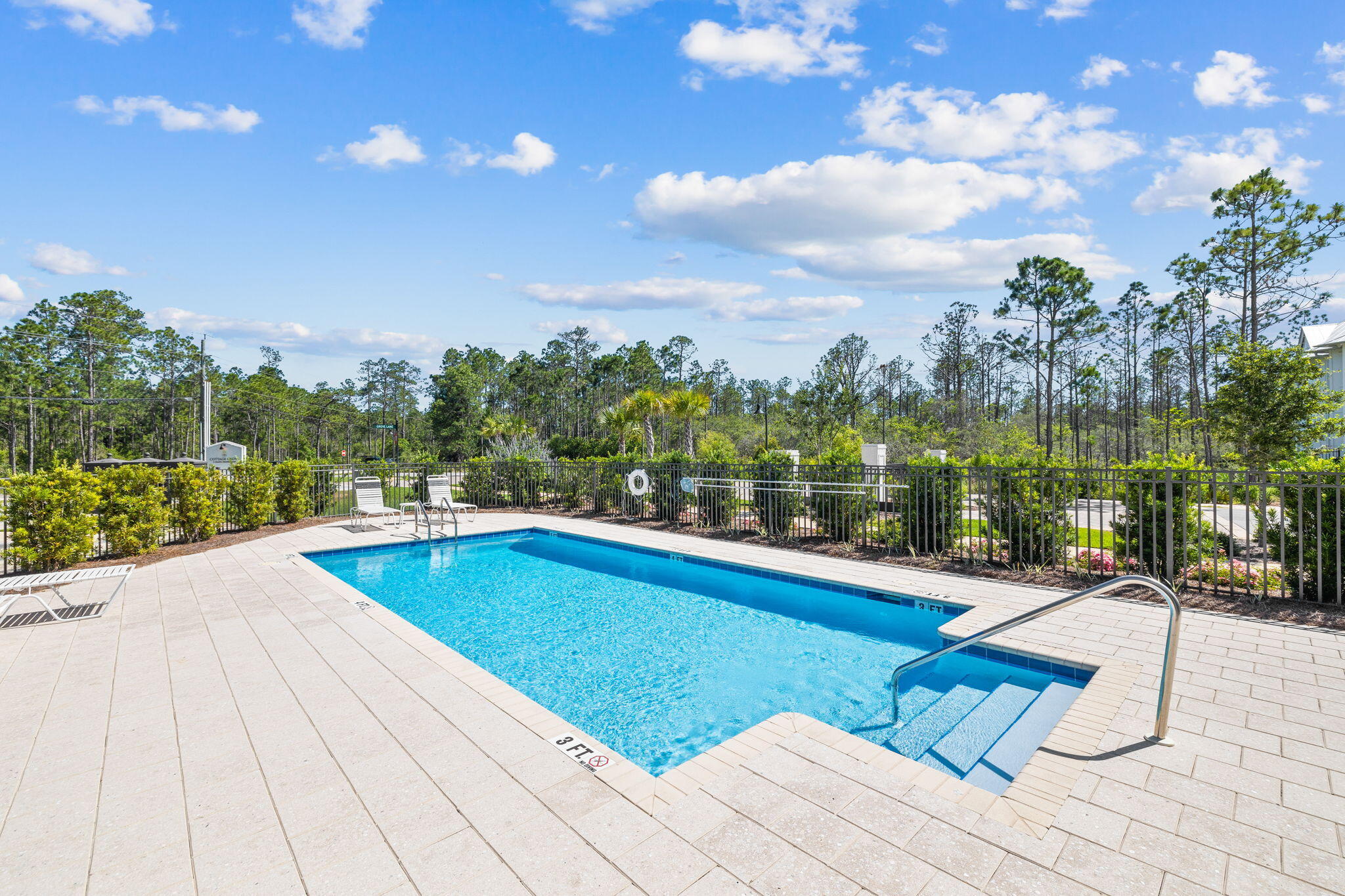 45 Grove Townhomes Place, Unit 104 Santa Rosa Beach, FL 32459 - Photo 34 of 36 a view of swimming pool with seating space and trees in the background