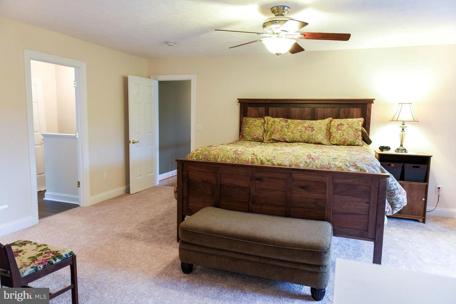 18522 Cherryfield Road Drayden, MD 20630 - Photo 12 of 30 a bedroom with a bed and a chandelier