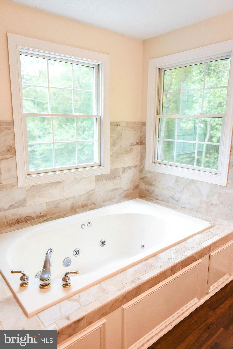 18522 Cherryfield Road Drayden, MD 20630 - Photo 16 of 30 a bathroom with a bathtub and next to a window