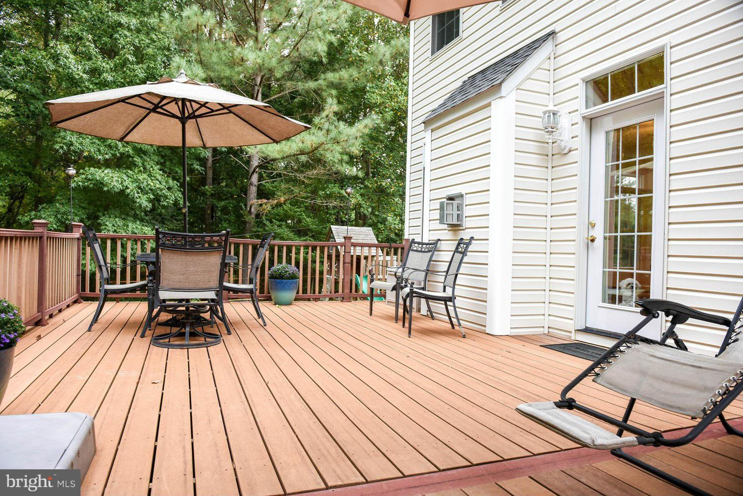 18522 Cherryfield Road Drayden, MD 20630 - Photo 21 of 30 a view of balcony with wooden floor and outdoor seating