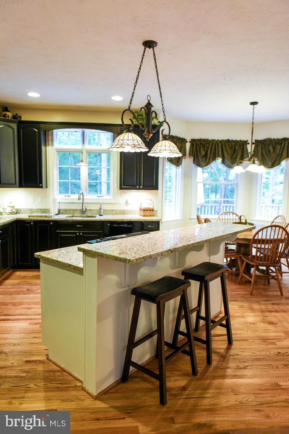 18522 Cherryfield Road Drayden, MD 20630 - Photo 4 of 30 a kitchen with a table and chairs in it