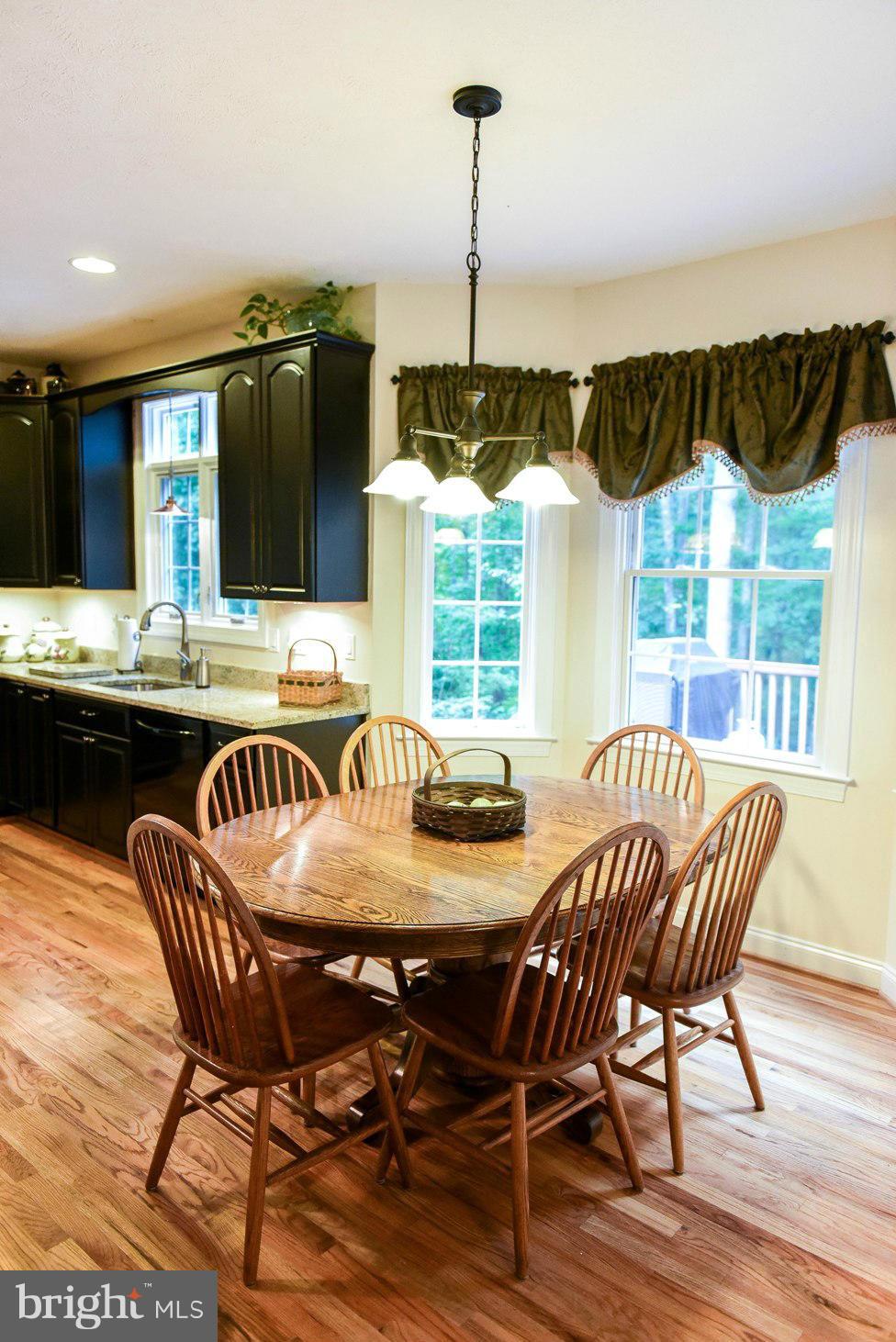 18522 Cherryfield Road Drayden, MD 20630 - Photo 6 of 30 a dining room with furniture window and wooden floor