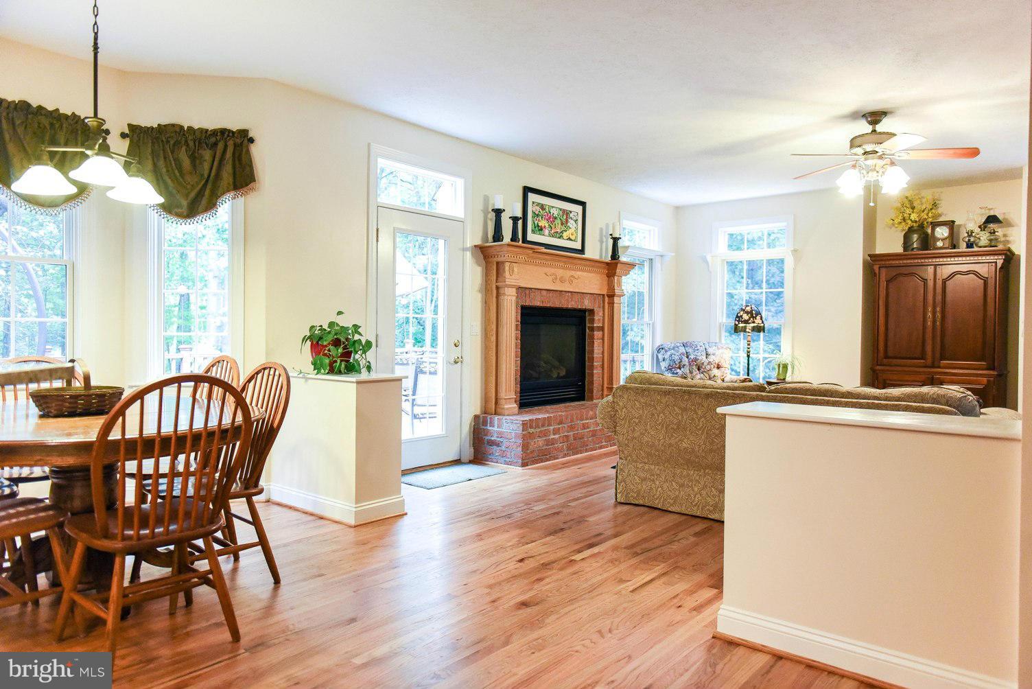18522 Cherryfield Road Drayden, MD 20630 - Photo 30 of 30 a living room with furniture a chandelier and a fireplace