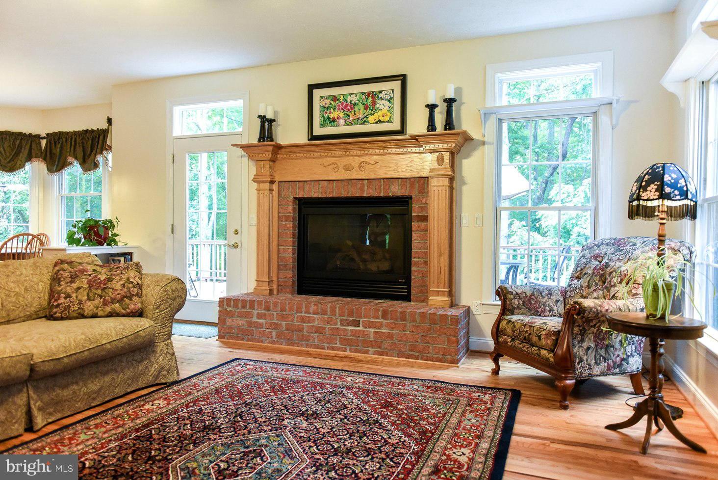 18522 Cherryfield Road Drayden, MD 20630 - Photo 7 of 30 a living room with furniture and a fireplace