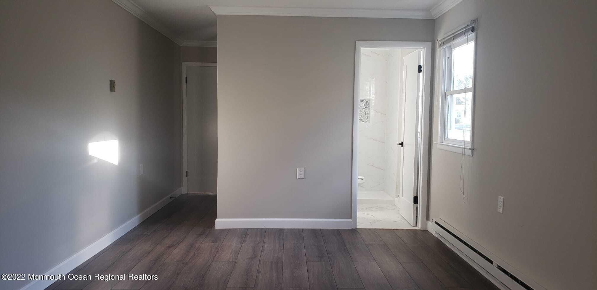 67 Markham Road Brick, NJ 08724 - Photo 15 of 16 an empty room with wooden floor and windows