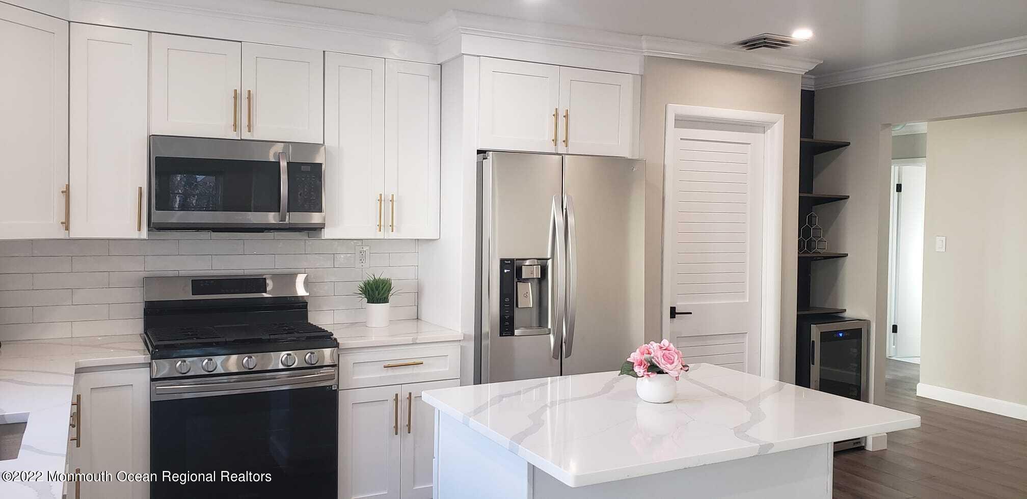 67 Markham Road Brick, NJ 08724 - Photo 4 of 16 a kitchen with stainless steel appliances a stove microwave and refrigerator