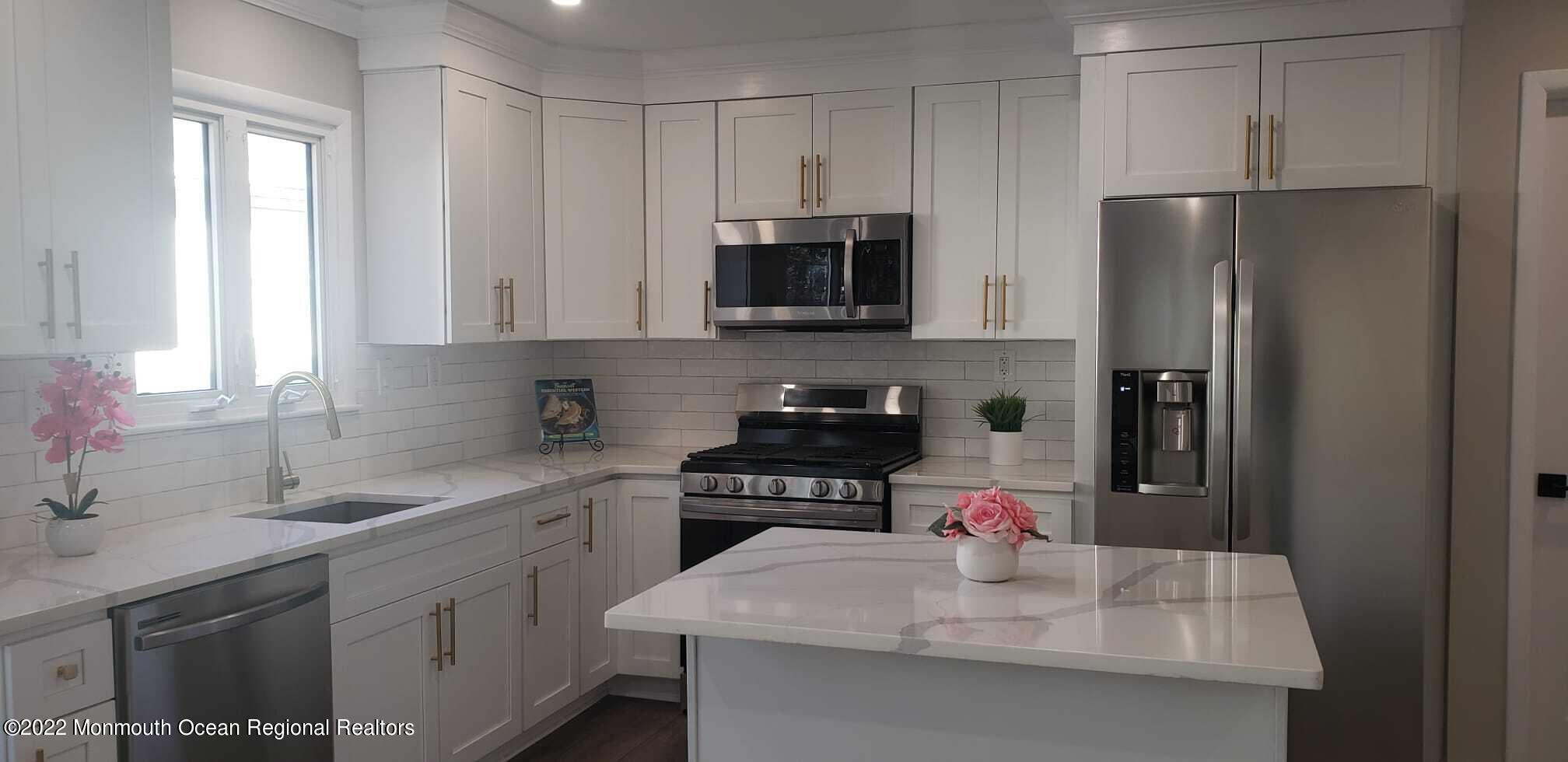 67 Markham Road Brick, NJ 08724 - Photo 5 of 16 a kitchen with a sink dishwasher a refrigerator and cabinets