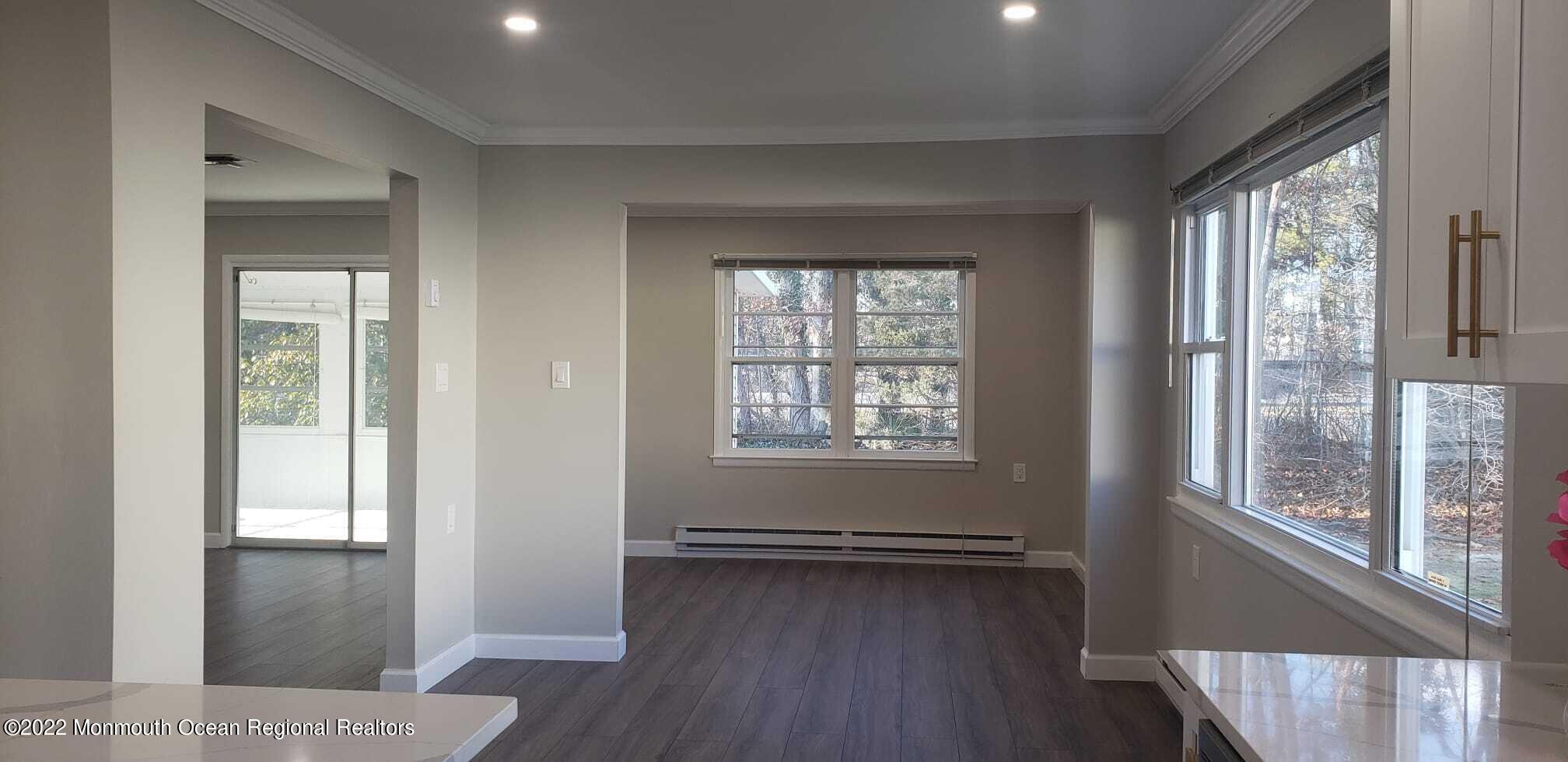 67 Markham Road Brick, NJ 08724 - Photo 6 of 16 a view of a room with wooden floor and windows