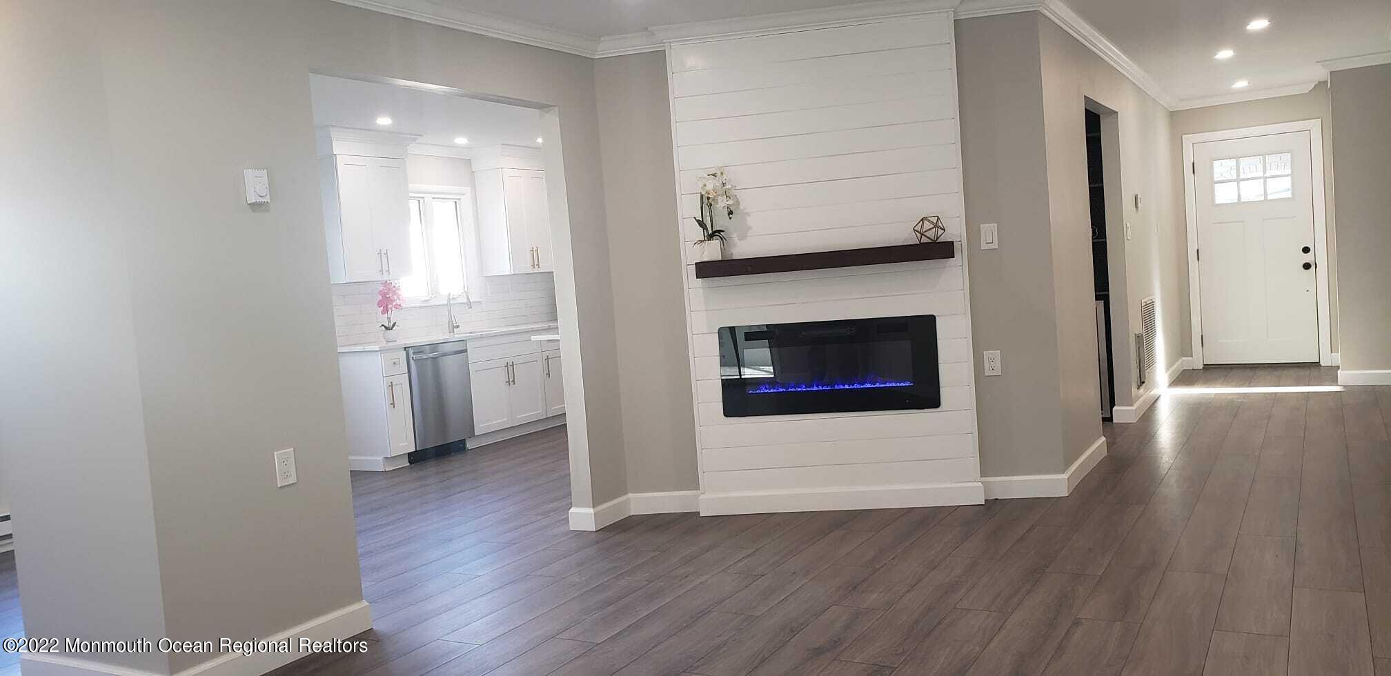 67 Markham Road Brick, NJ 08724 - Photo 7 of 16 a view of empty room with wooden floor and fireplace