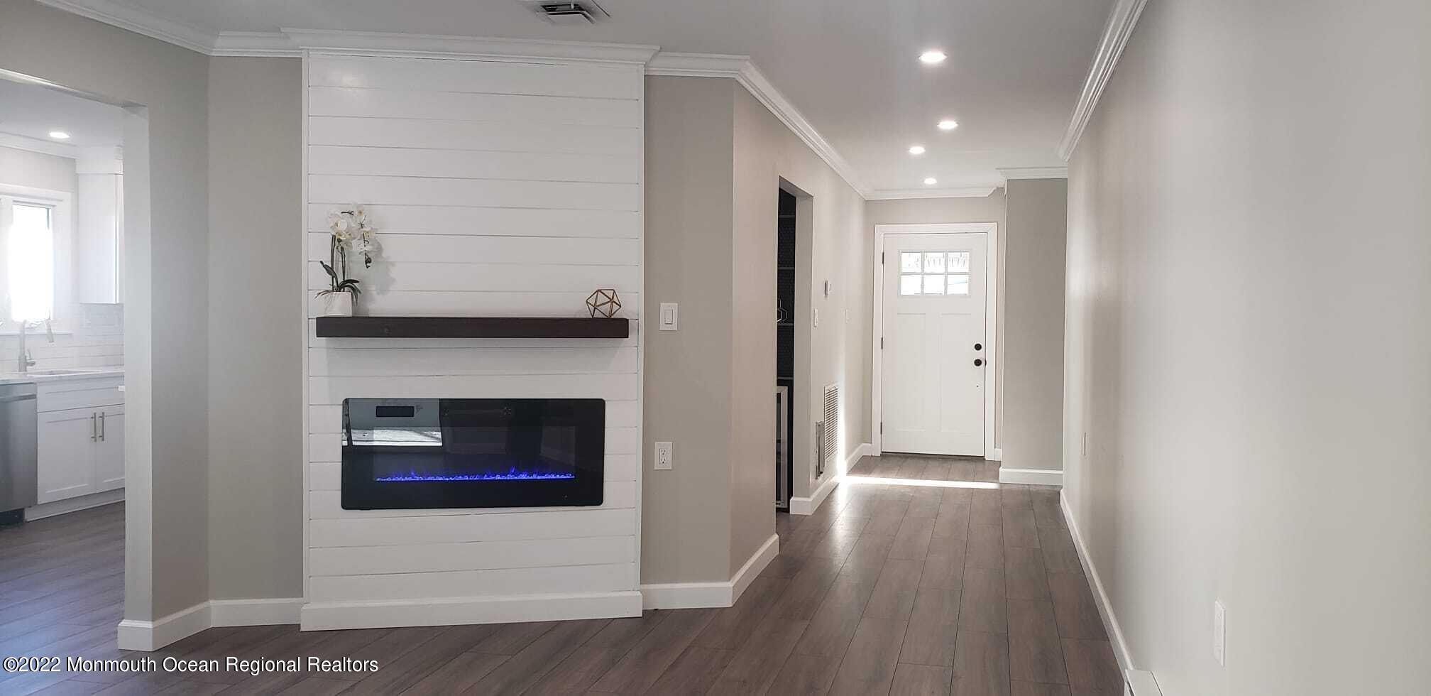 67 Markham Road Brick, NJ 08724 - Photo 9 of 16 a view of a hallway with entryway wooden floor and front door