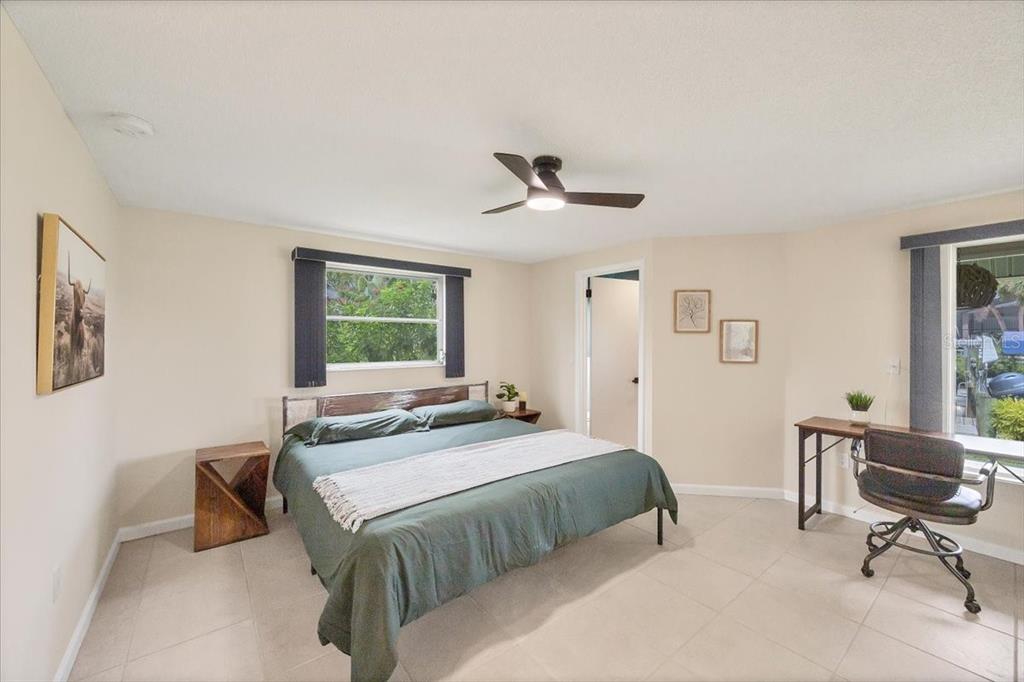 4696 Pompano Street Placida, FL 33946 - Photo 12 of 23 a bedroom with a bed a couch and a window