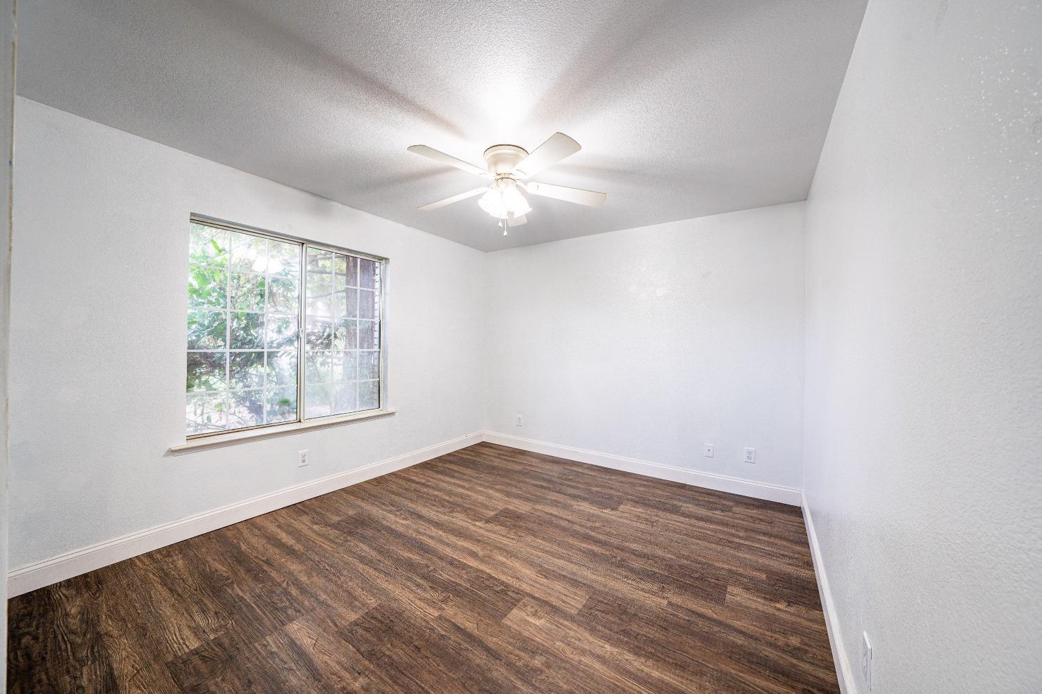 118 Oak Avenue Clovis, CA 93611 - Photo 14 of 22 wooden floor in an empty room with a window