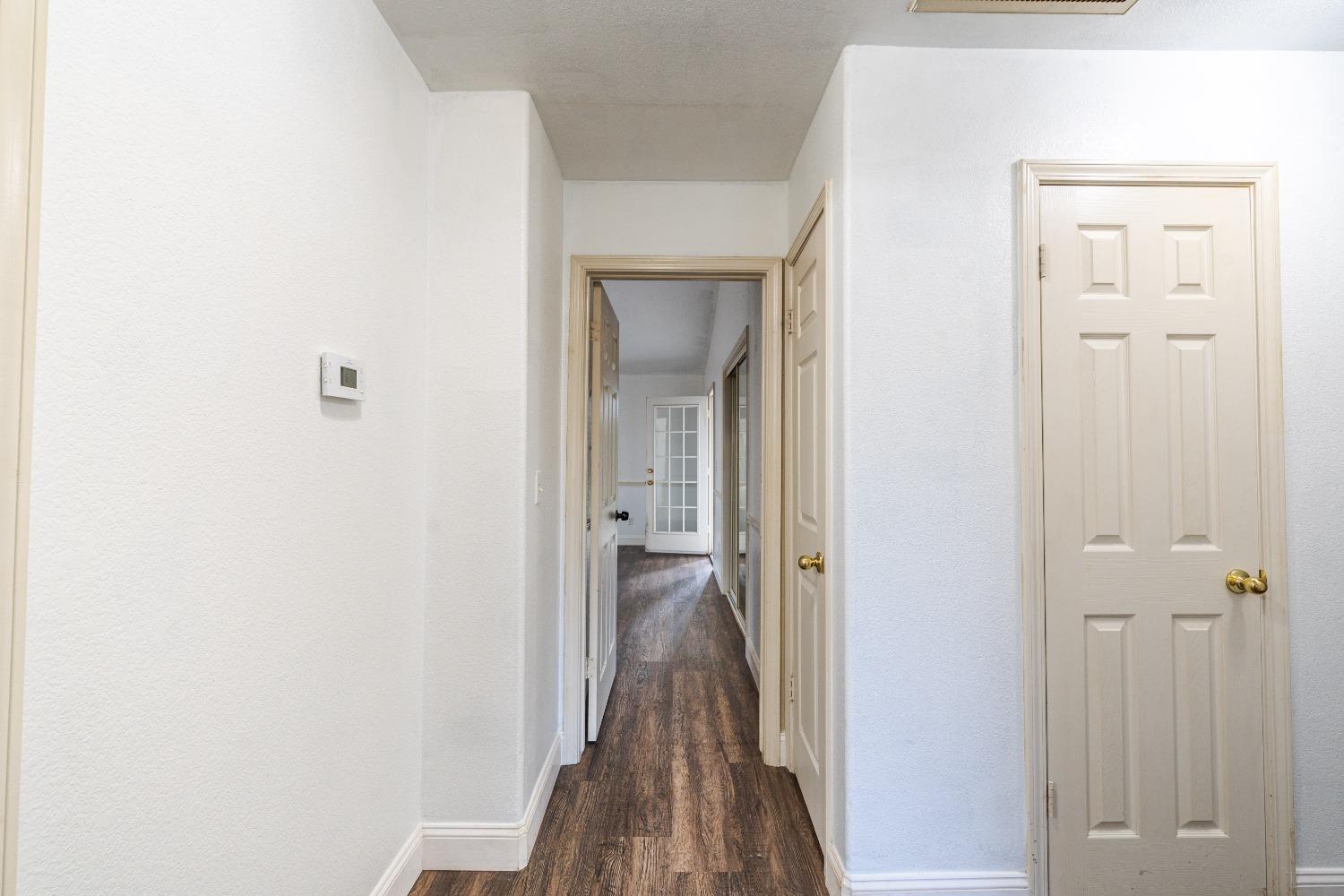 118 Oak Avenue Clovis, CA 93611 - Photo 15 of 22 a view of a hallway with wooden floor