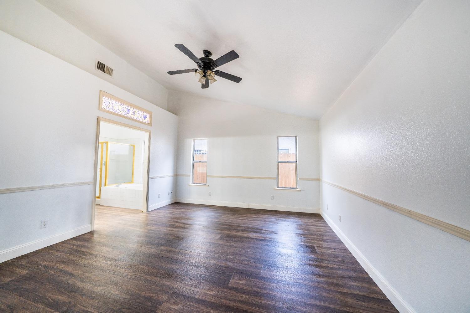 118 Oak Avenue Clovis, CA 93611 - Photo 17 of 22 a view of empty room with wooden floor and window