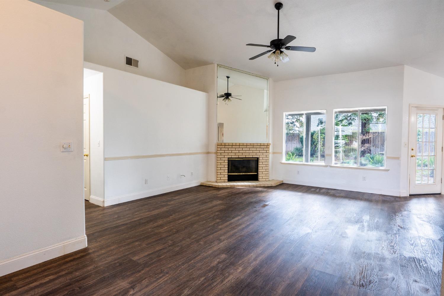 118 Oak Avenue Clovis, CA 93611 - Photo 5 of 22 a view of a livingroom with wooden floor a ceiling fan and windows