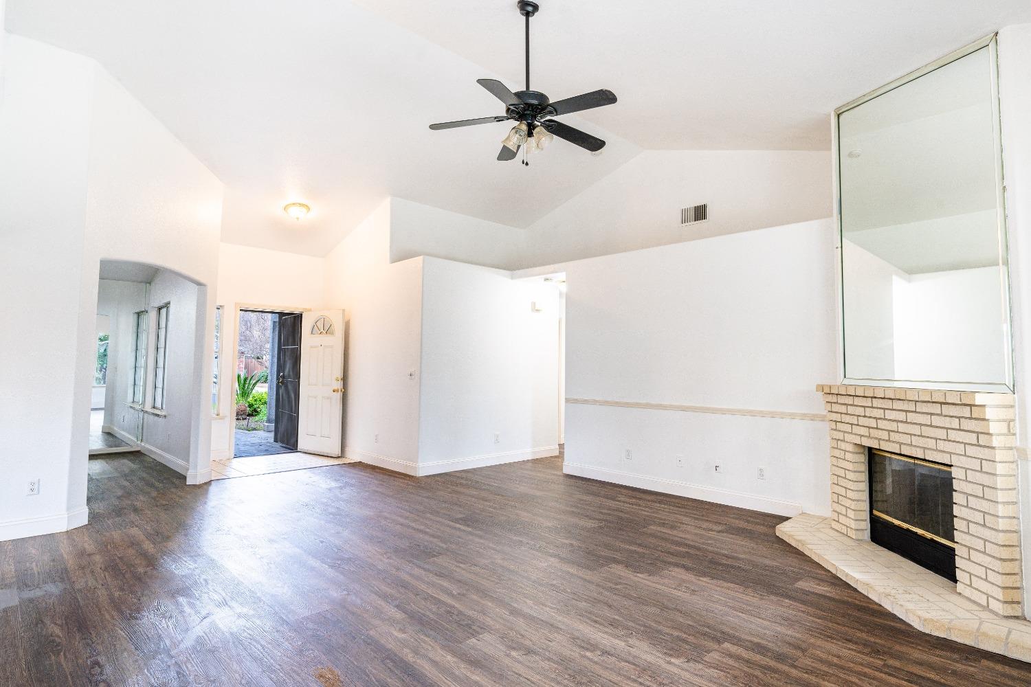 118 Oak Avenue Clovis, CA 93611 - Photo 6 of 22 a view of a livingroom with wooden floor and a ceiling fan