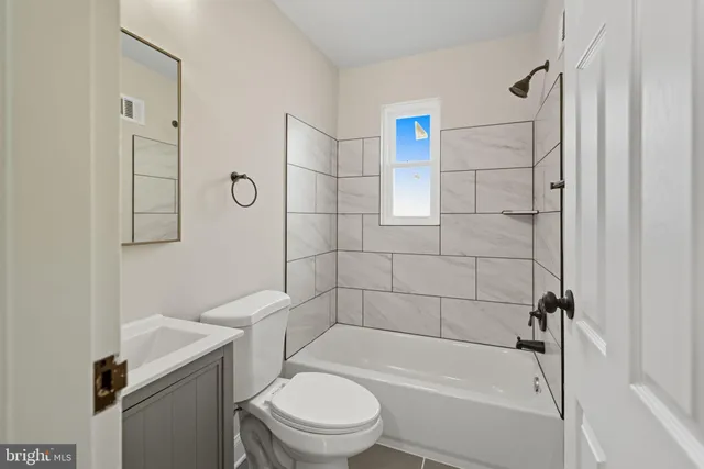 a bathroom with a toilet and shower