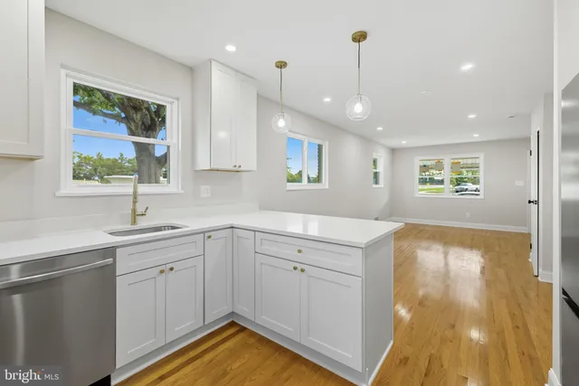 a kitchen with a sink window and cabinets