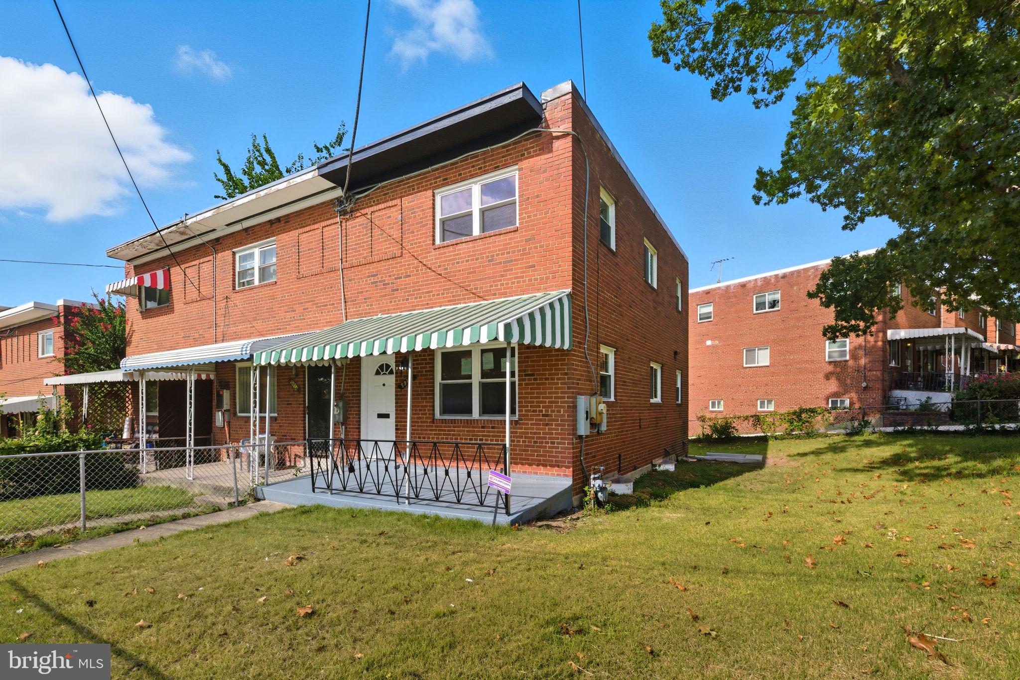 5916 8th Street Northeast Washington, DC 20011 - Photo 27 of 29 a front view of a house with a yard