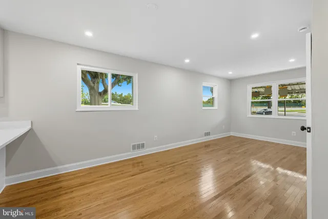 a view of room with window and wooden floor