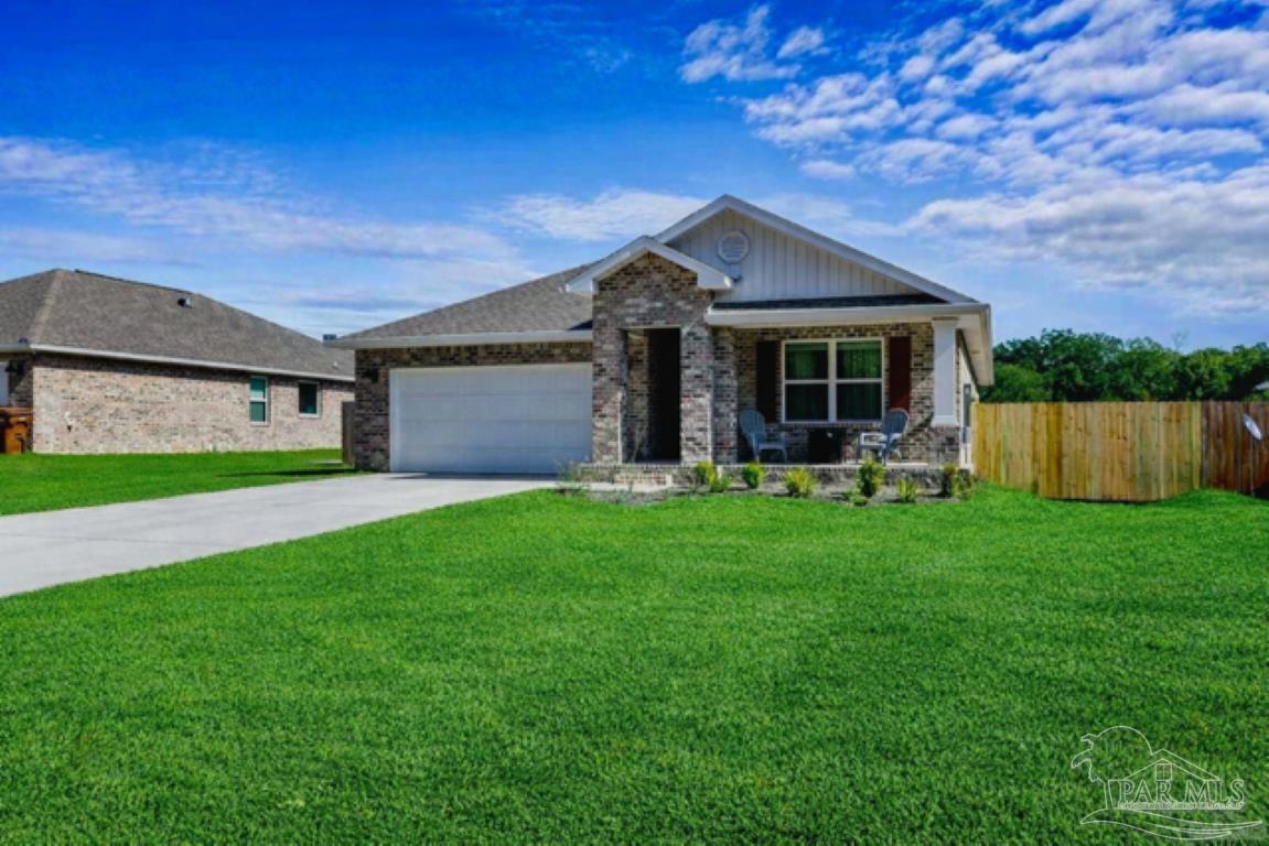 a front view of house with yard and green space