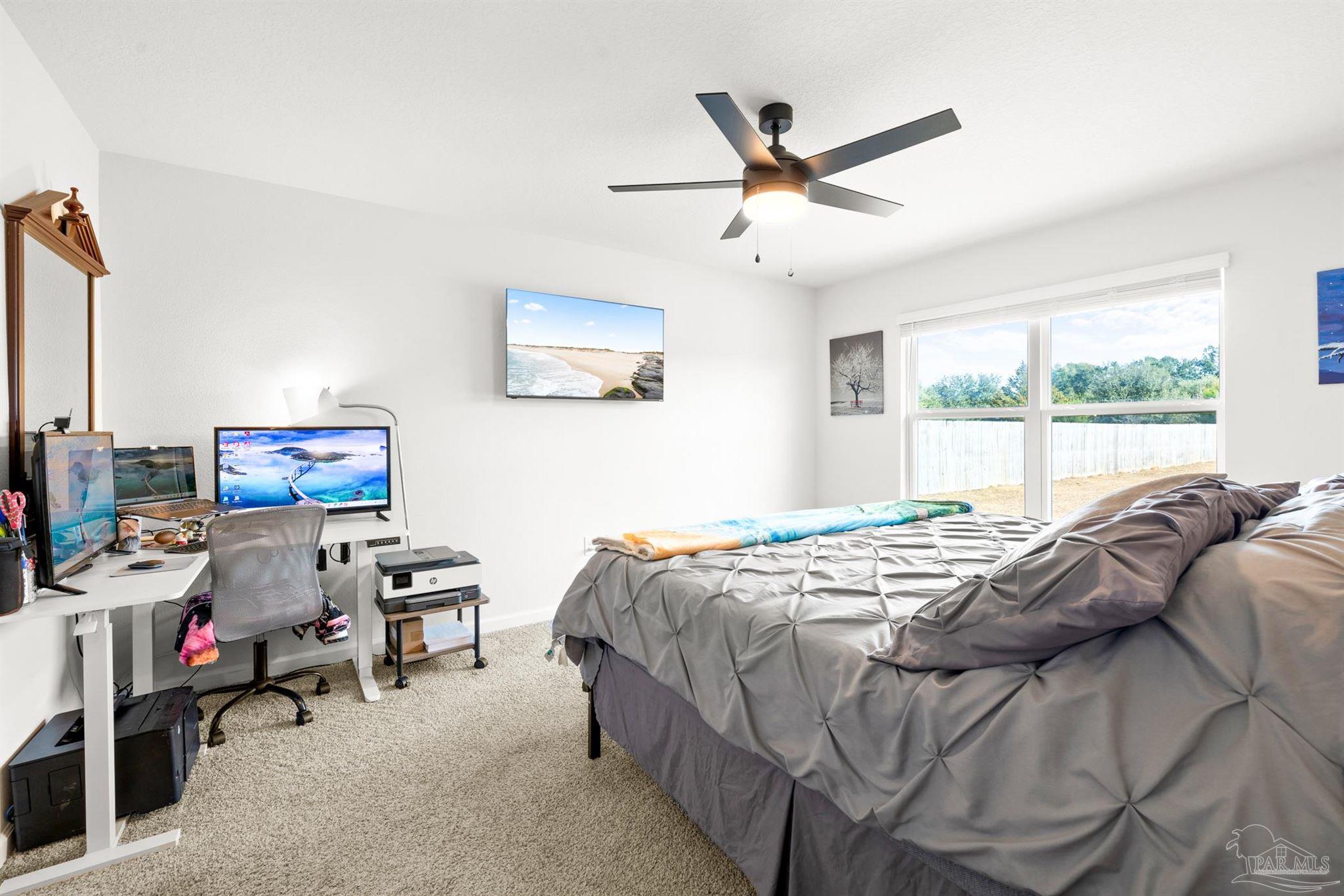 4774 Carl Booker Road Milton, FL 32583 - Photo 11 of 35 a bedroom that has a bed and a window