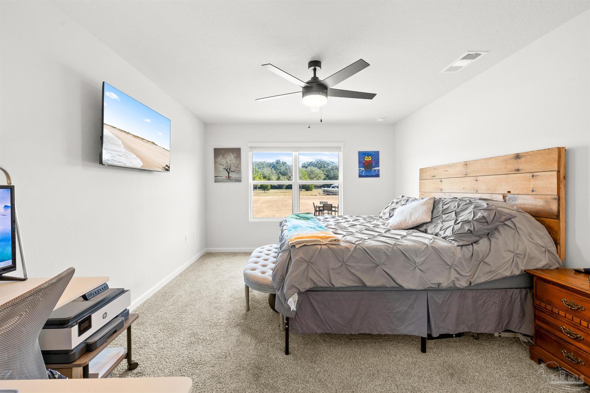 4774 Carl Booker Road Milton, FL 32583 - Photo 12 of 35 a bedroom with a bed and a window