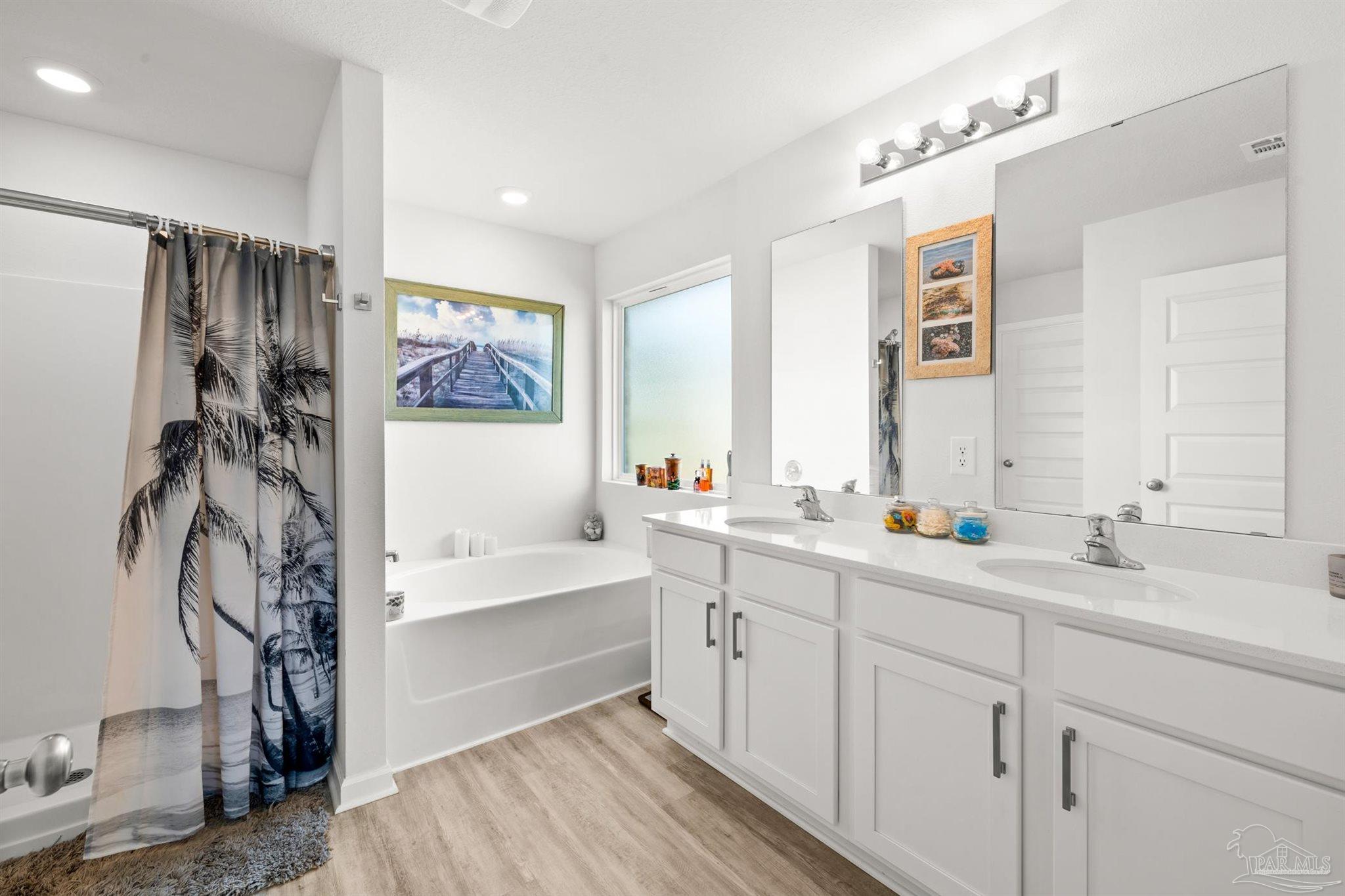 4774 Carl Booker Road Milton, FL 32583 - Photo 13 of 35 a spacious bathroom with a double vanity sink a mirror and a shower