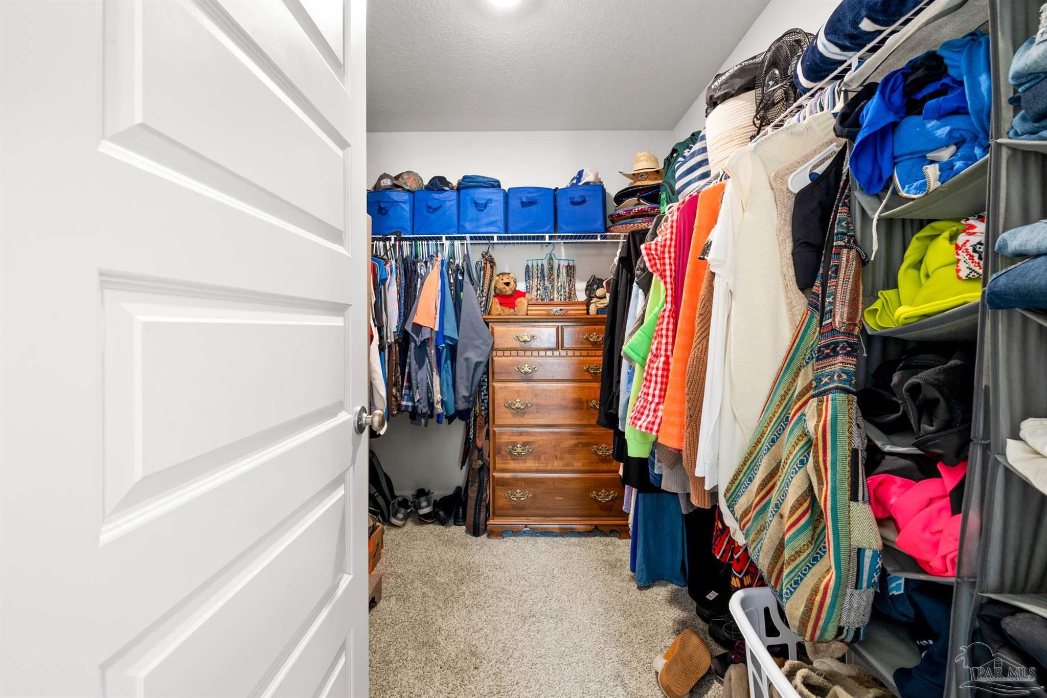 4774 Carl Booker Road Milton, FL 32583 - Photo 17 of 35 a view of walk in closet with clothes and shoes