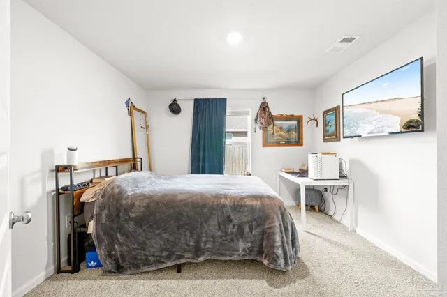 a bedroom with a bed and a desk