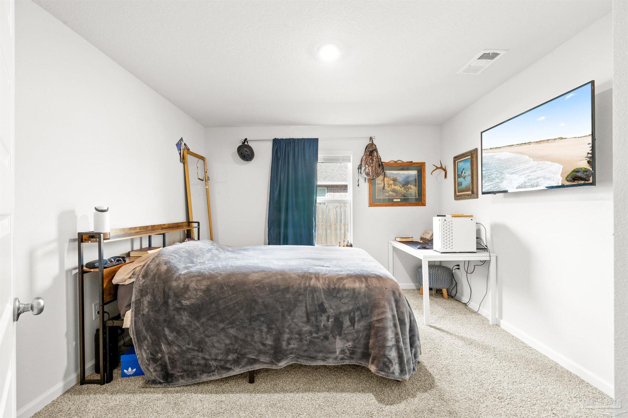 4774 Carl Booker Road Milton, FL 32583 - Photo 18 of 35 a bedroom with a bed and a desk