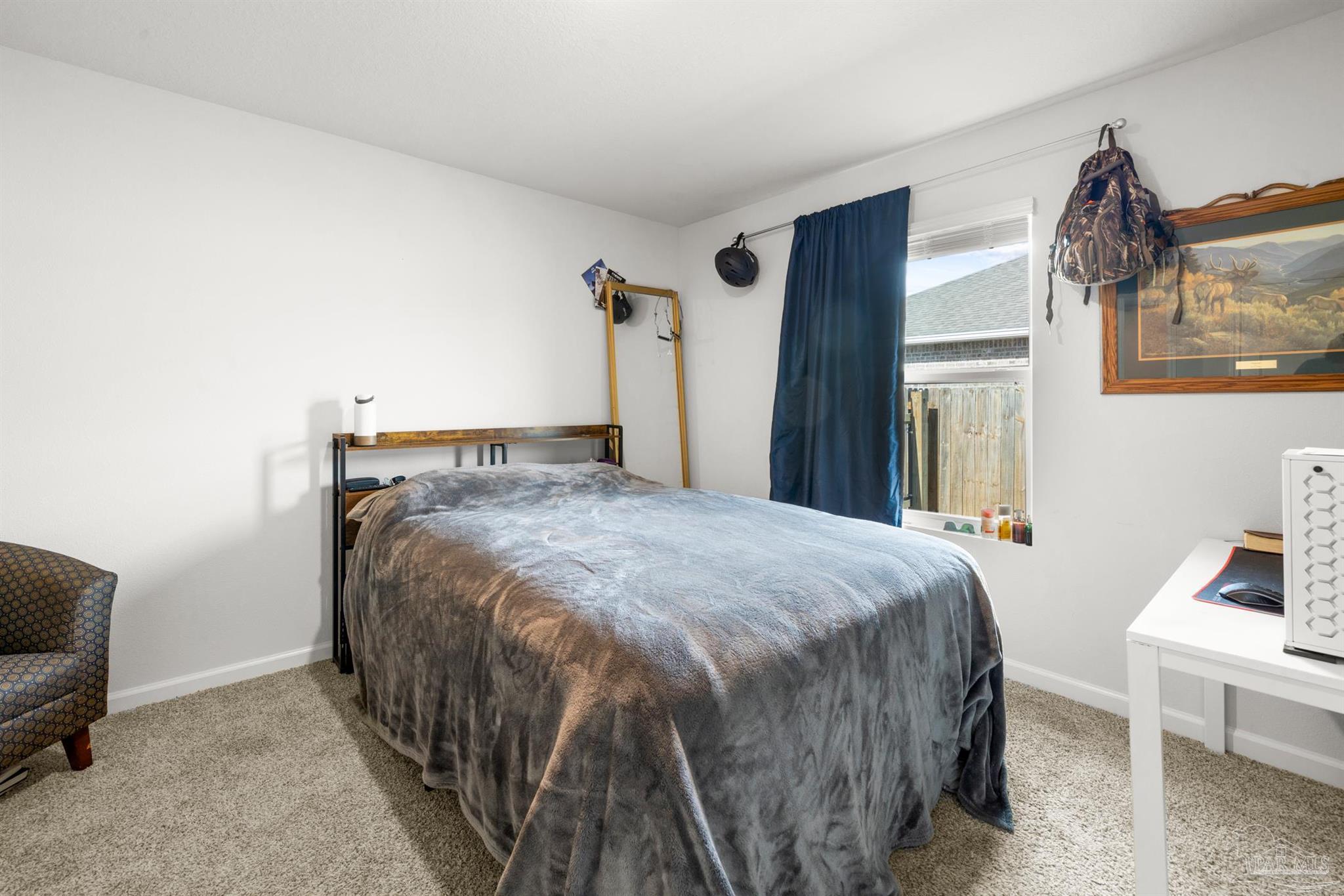 4774 Carl Booker Road Milton, FL 32583 - Photo 20 of 35 a bedroom with a bed and a couch