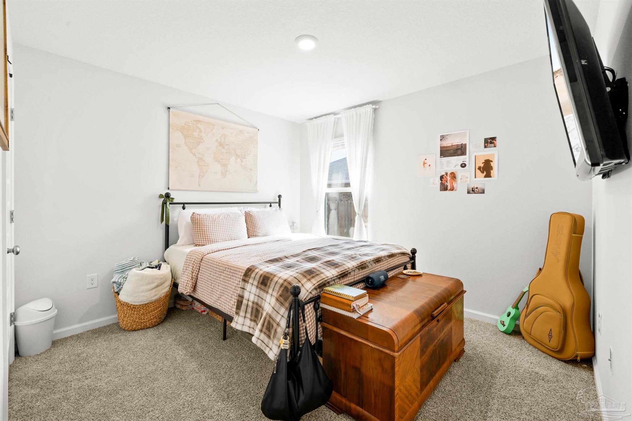 4774 Carl Booker Road Milton, FL 32583 - Photo 21 of 35 a bedroom with a bed and a flat tv screen on the dresser
