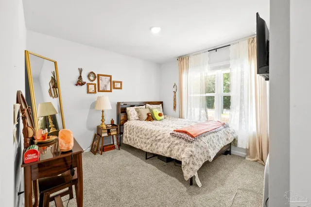 a bed room with a bed and a window