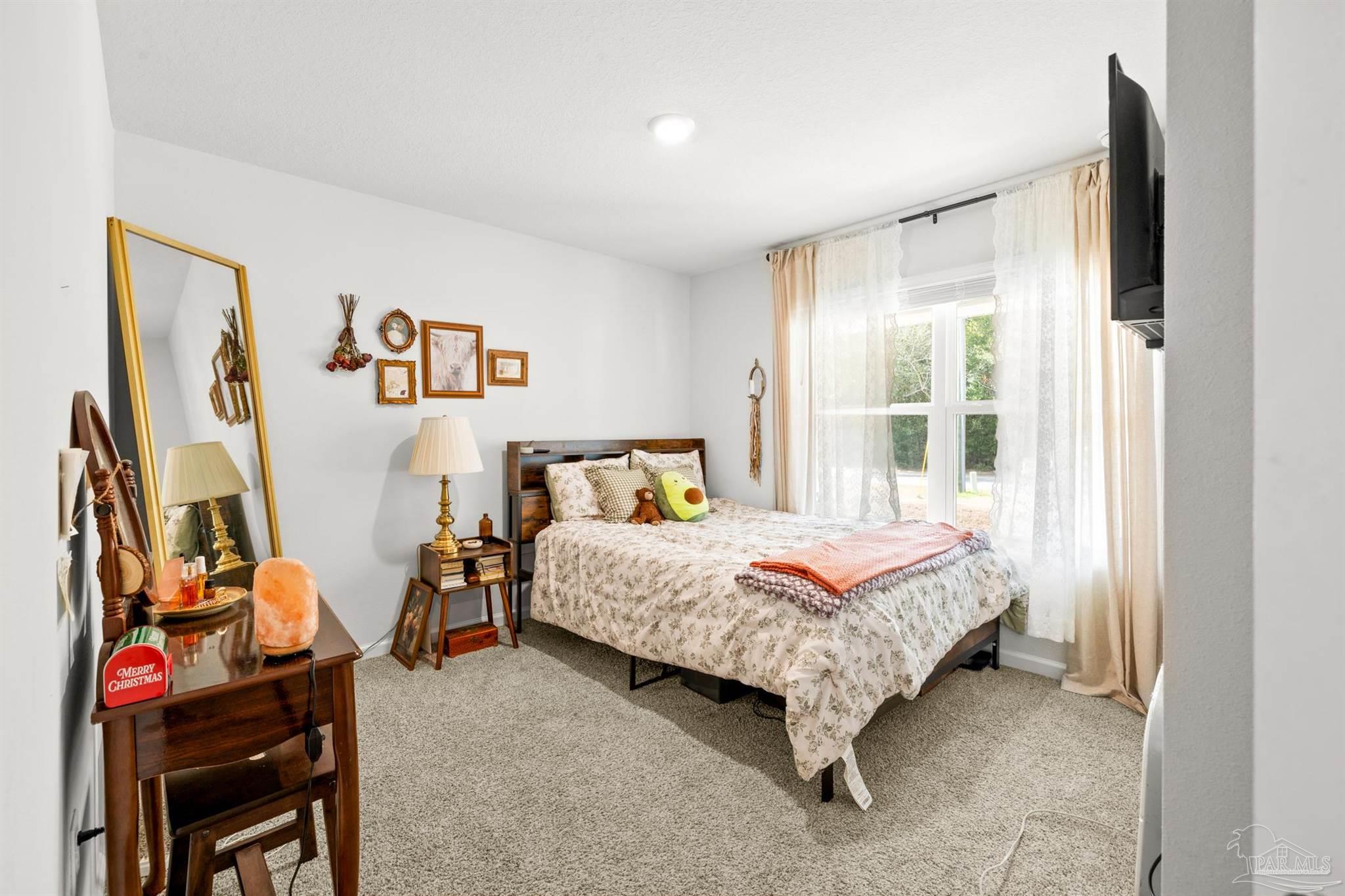 4774 Carl Booker Road Milton, FL 32583 - Photo 23 of 35 a bed room with a bed and a window