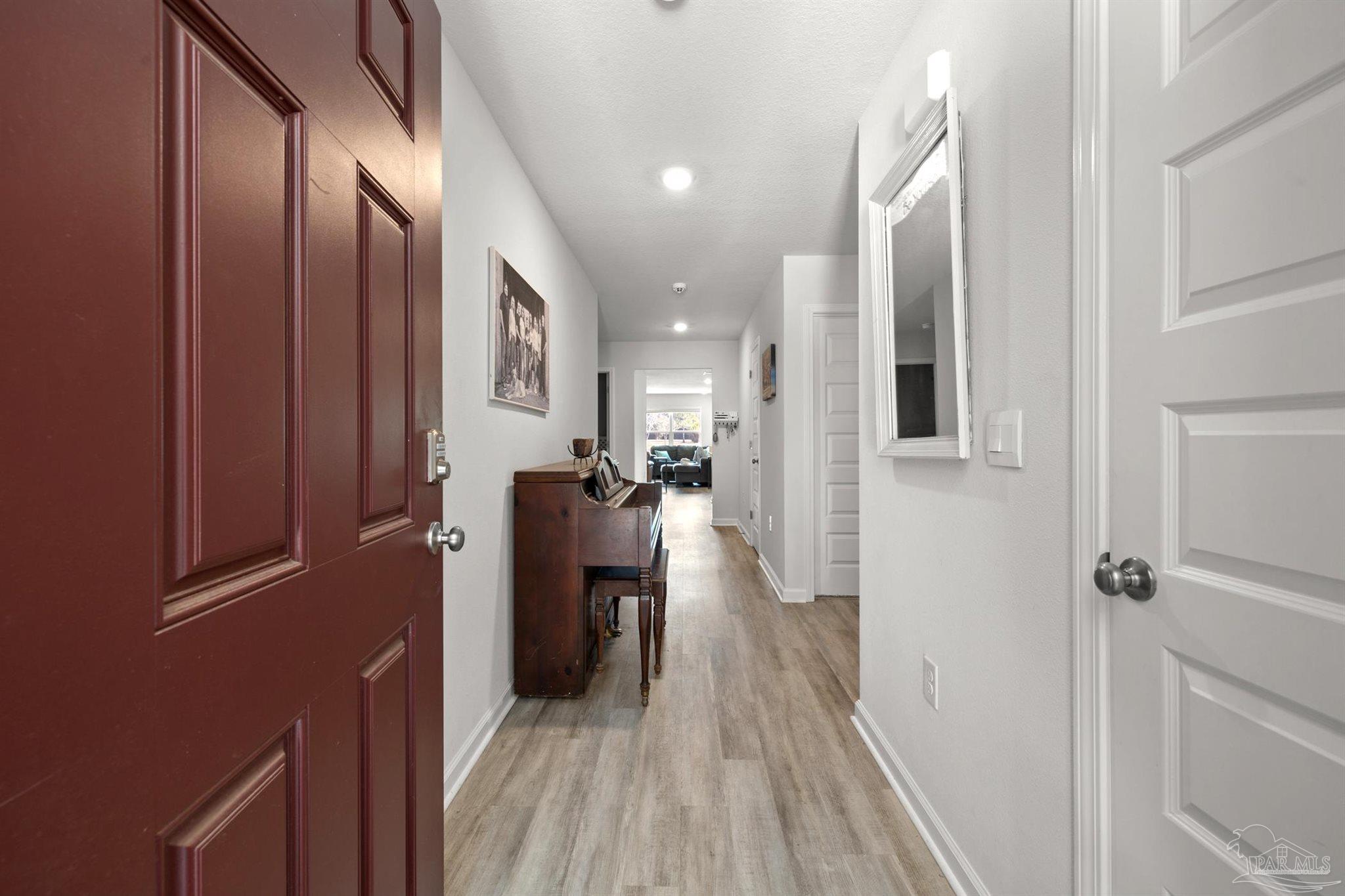 4774 Carl Booker Road Milton, FL 32583 - Photo 24 of 35 a view of a hallway with wooden floor and staircase