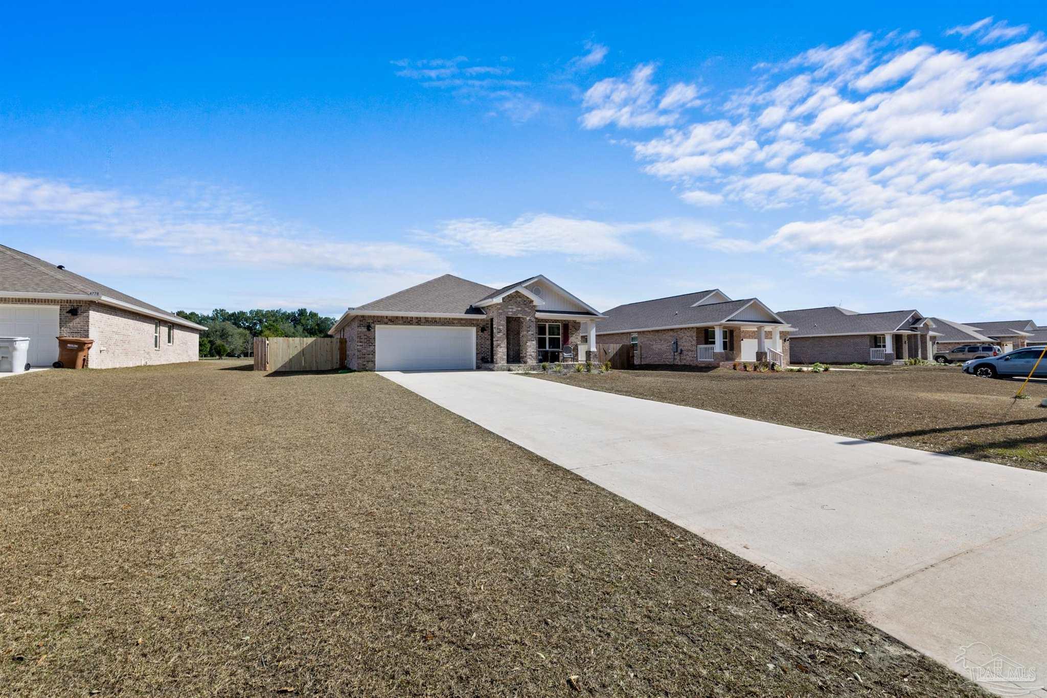 4774 Carl Booker Road Milton, FL 32583 - Photo 27 of 35 a front view of a house with a yard