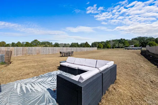 a view of a backyard with brick wall