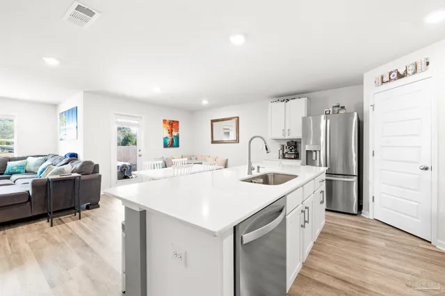 a kitchen with a sink and a refrigerator