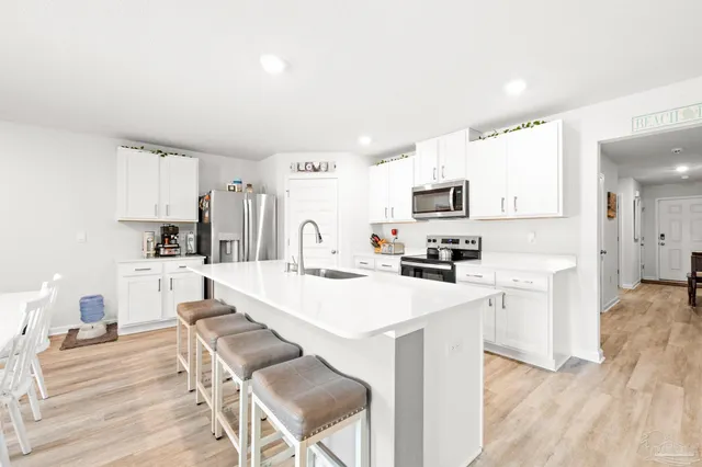 a kitchen with a stove a sink and a refrigerator