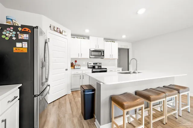 a kitchen with a sink cabinets and refrigerator