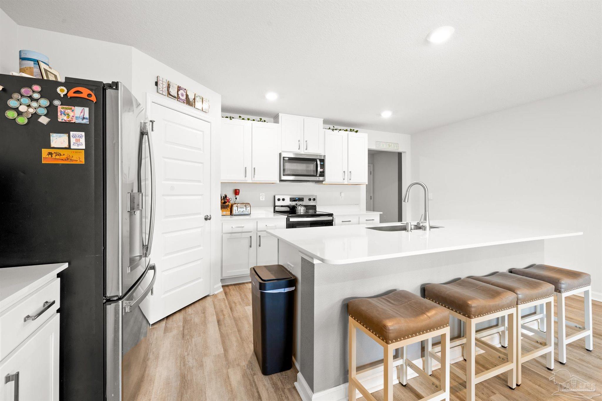 4774 Carl Booker Road Milton, FL 32583 - Photo 5 of 35 a kitchen with a sink cabinets and refrigerator