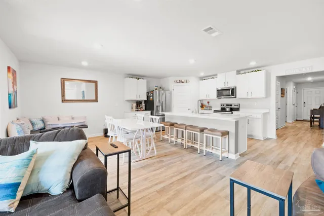 a living room with furniture and kitchen view
