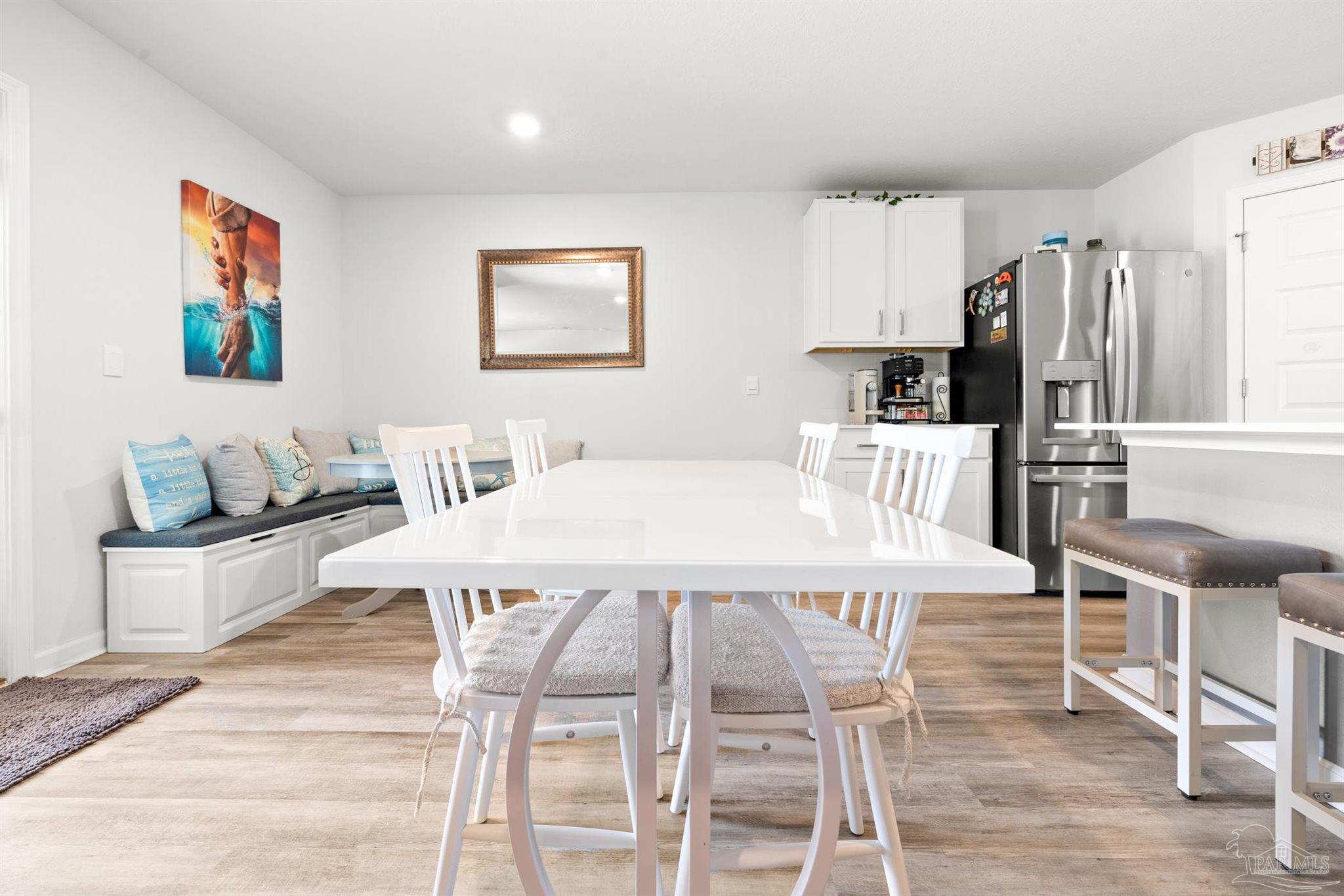 4774 Carl Booker Road Milton, FL 32583 - Photo 8 of 35 a dining room with stainless steel appliances furniture a large window and a kitchen view