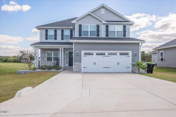 a front view of a house with a yard and garage