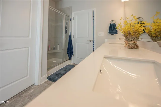 a bed sitting in a room and kitchen view