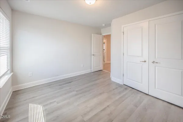 a spacious bedroom with a bed and a cabinets