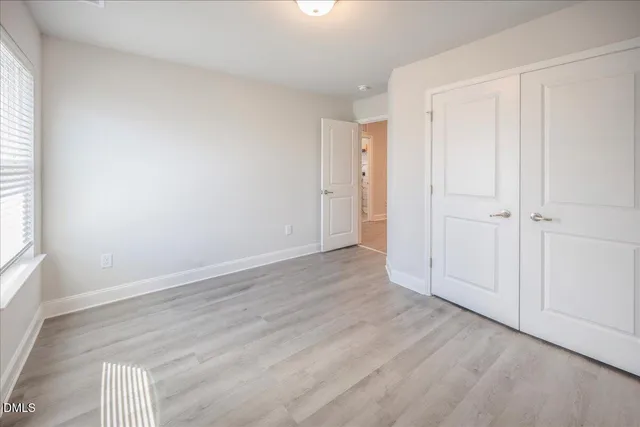 a spacious bedroom with a bed and a cabinets